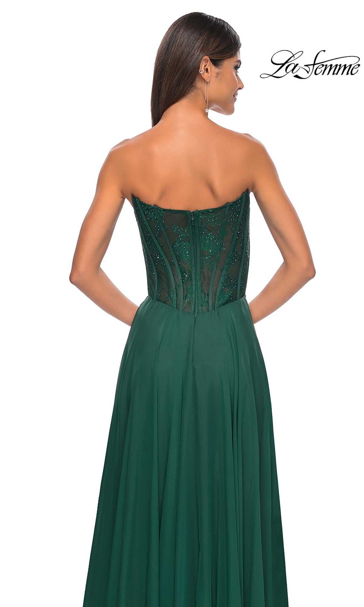 A woman is shown from the back in the La Femme Lace-Bodice Long A-Line Prom Dress 32311, featuring a dark green strapless design with a fitted lace bodice and flowing skirt.
